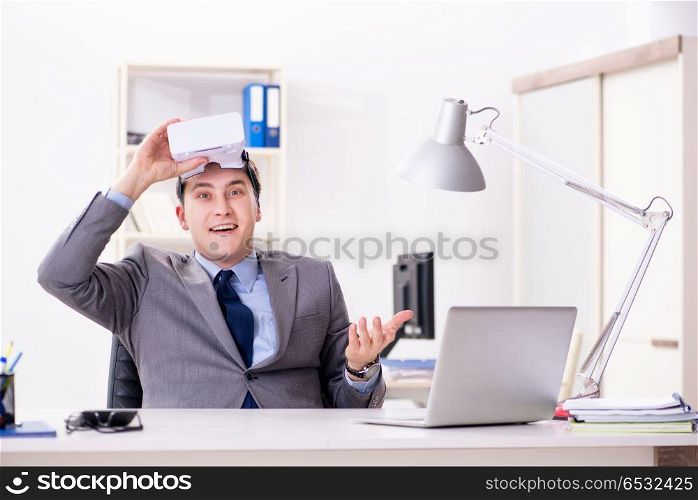 Businessman with virtual reality glasses in office
