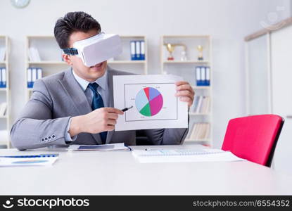 Businessman with virtual reality glasses in the office