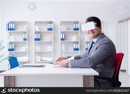 Businessman with virtual reality glasses in the office