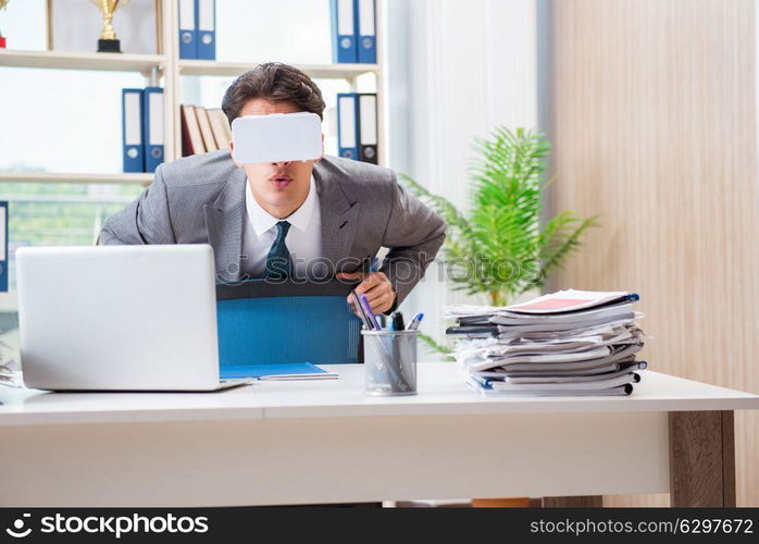 Businessman with VR virtual reality glasses in office