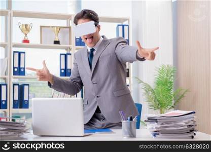 Businessman with VR virtual reality glasses in office. The businessman with vr virtual reality glasses in office