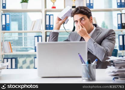 Businessman with VR virtual reality glasses in office