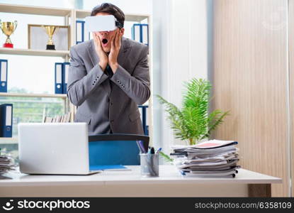 Businessman with VR virtual reality glasses in office