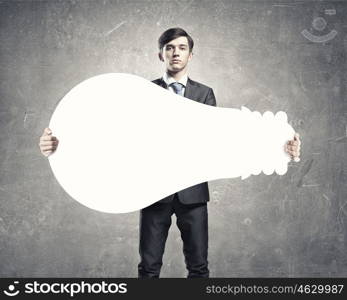 Businessman with white banner. Young businessman holding light bulb paper concept