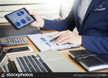 Businessman work on Desk office business financial analysis charts or graphs accounting  calculating bugget money tax loan inspector making report.