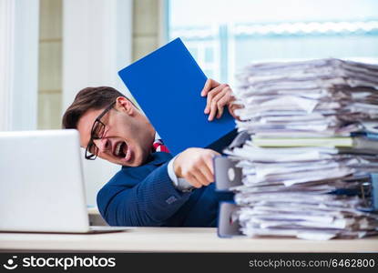 Businessman workaholic struggling with pile of paperwork