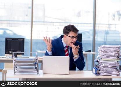 Businessman workaholic struggling with pile of paperwork