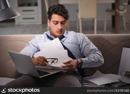 Businessman workaholic working late at home