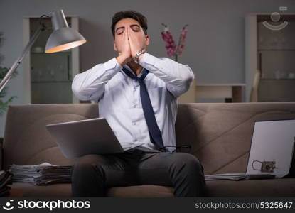 Businessman workaholic working late at home