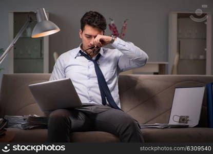 Businessman workaholic working late at home