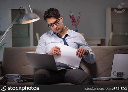 Businessman workaholic working late at home