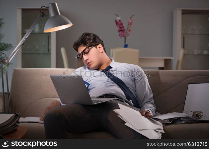 Businessman workaholic working late at home