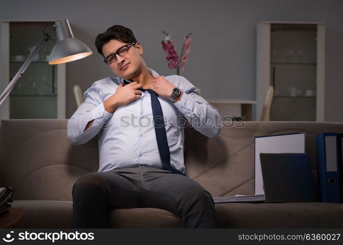 Businessman workaholic working late at home