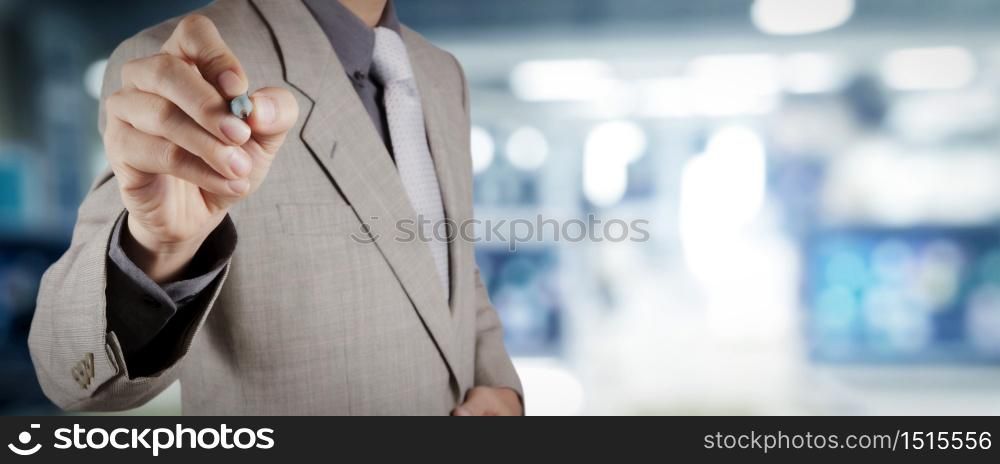 businessman workimg on VR blank wide touch screen computer on office blur background.