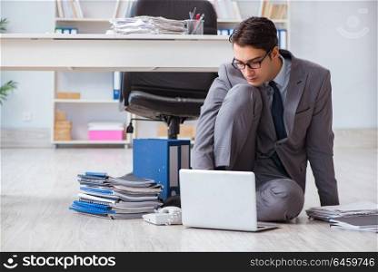 Businessman working and sitting on floor in office