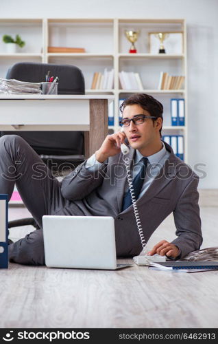 Businessman working and sitting on floor in office