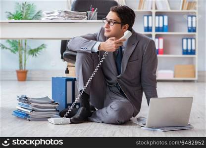 Businessman working and sitting on floor in office