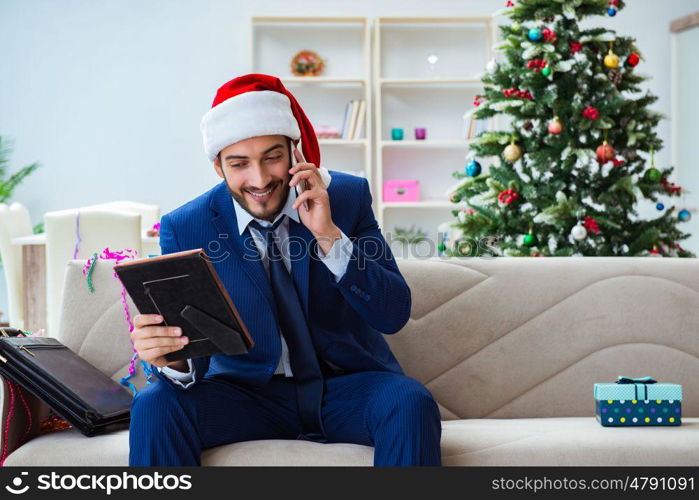 Businessman working at home during christmas