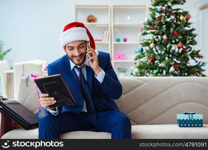 Businessman working at home during christmas