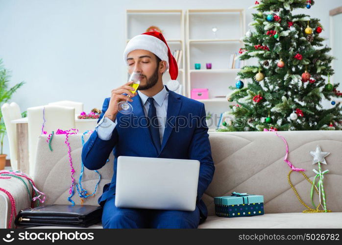 Businessman working at home during christmas