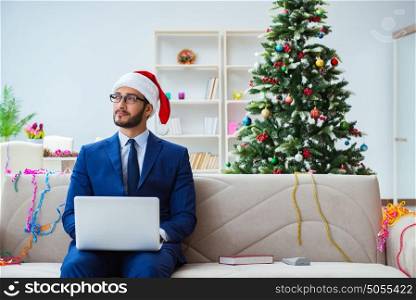 Businessman working at home during christmas