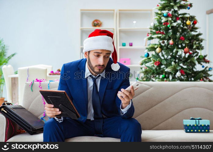 Businessman working at home during christmas