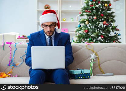 Businessman working at home during christmas