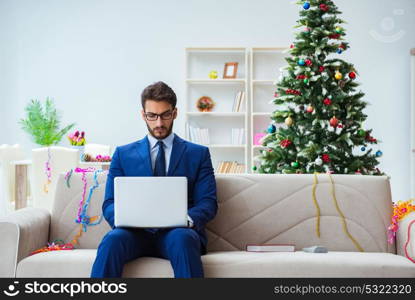 Businessman working at home during christmas