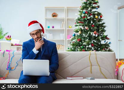 Businessman working at home during christmas