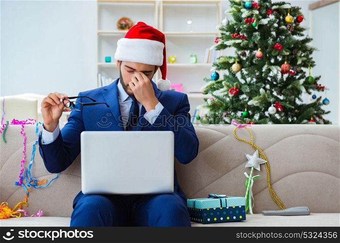 Businessman working at home during christmas