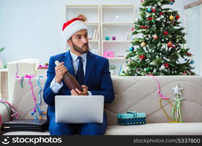 Businessman working at home during christmas