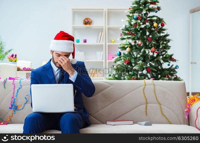 Businessman working at home during christmas