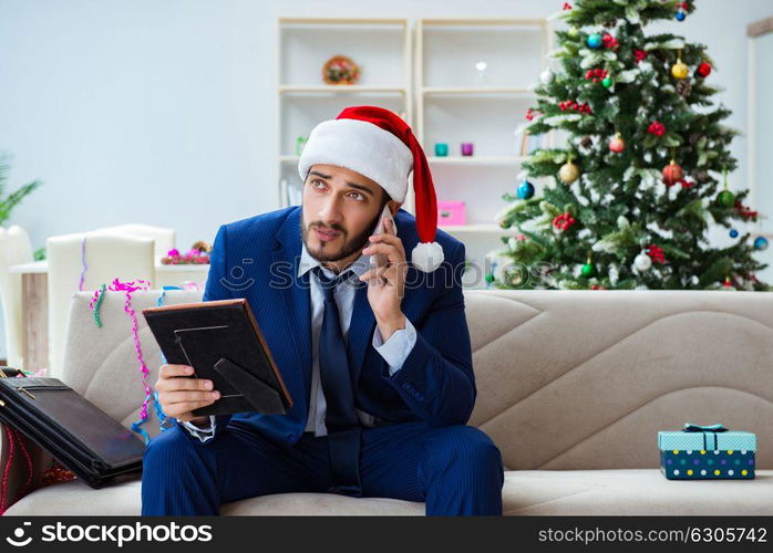 Businessman working at home during christmas