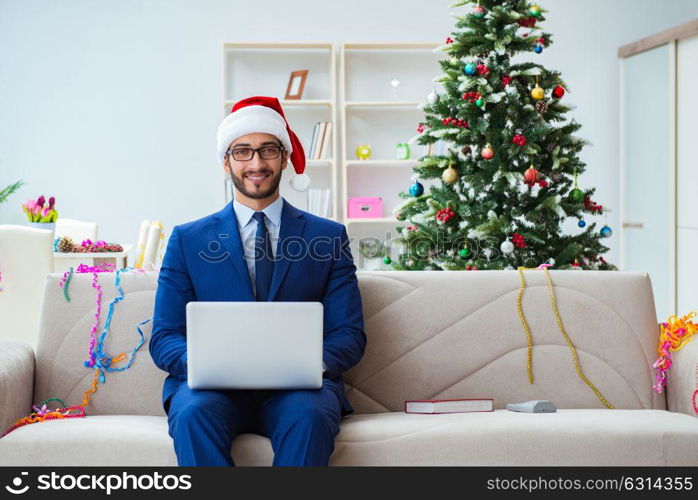 Businessman working at home during christmas