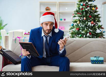 Businessman working at home during christmas