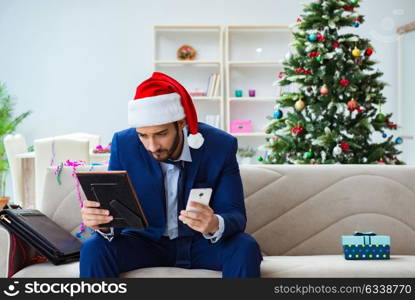 Businessman working at home during christmas