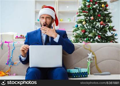 Businessman working at home during christmas. The businessman working at home during christmas