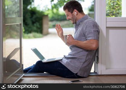 Businessman Working From Home On Video Call During Pandemic Lockdown