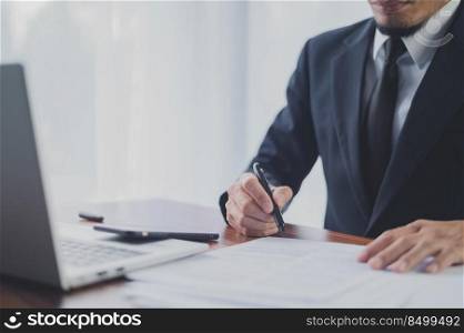 Businessman working in office and hand writing on document financial business management for business planning 2022 to 2023