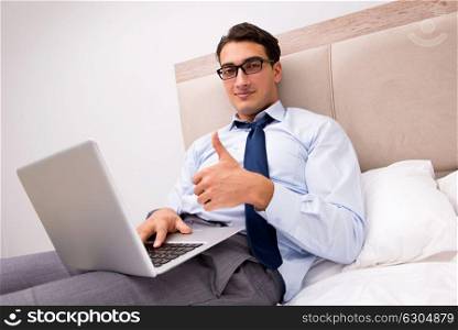 Businessman working in the bed at home