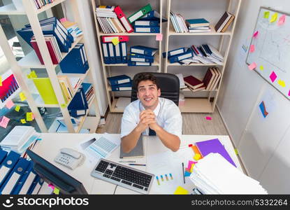 Businessman working in the office with piles of books and papers. Businessman working in the office with piles of books and papers doing paperwork