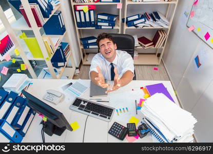 Businessman working in the office with piles of books and papers. Businessman working in the office with piles of books and papers doing paperwork