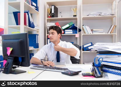 Businessman working in the office with piles of books and papers. Businessman working in the office with piles of books and papers doing paperwork