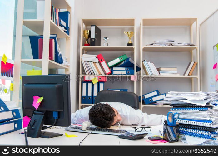 Businessman working in the office with piles of books and papers. Businessman working in the office with piles of books and papers doing paperwork