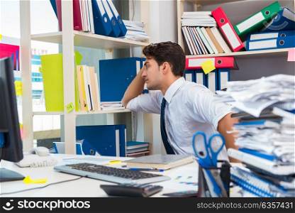 Businessman working in the office with piles of books and papers. Businessman working in the office with piles of books and papers doing paperwork