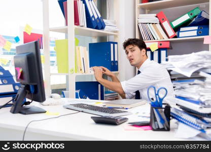 Businessman working in the office with piles of books and papers. Businessman working in the office with piles of books and papers doing paperwork