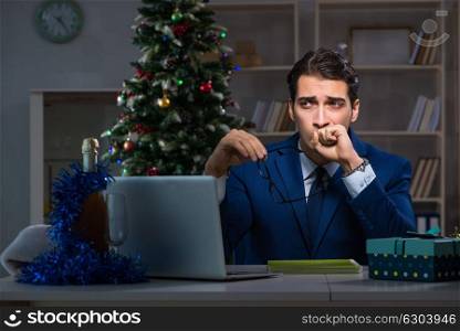 Businessman working late on christmas day in office