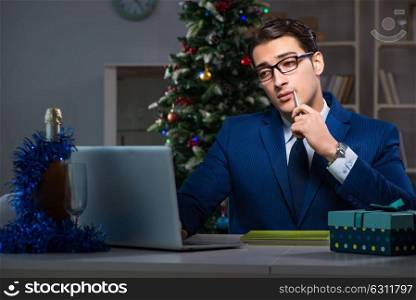 Businessman working late on christmas day in office. The businessman working late on christmas day in office