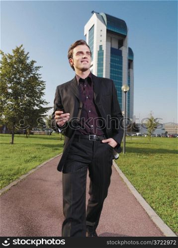 Businessman working near office with mobie phone