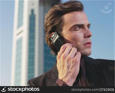 Businessman working near office with mobie phone